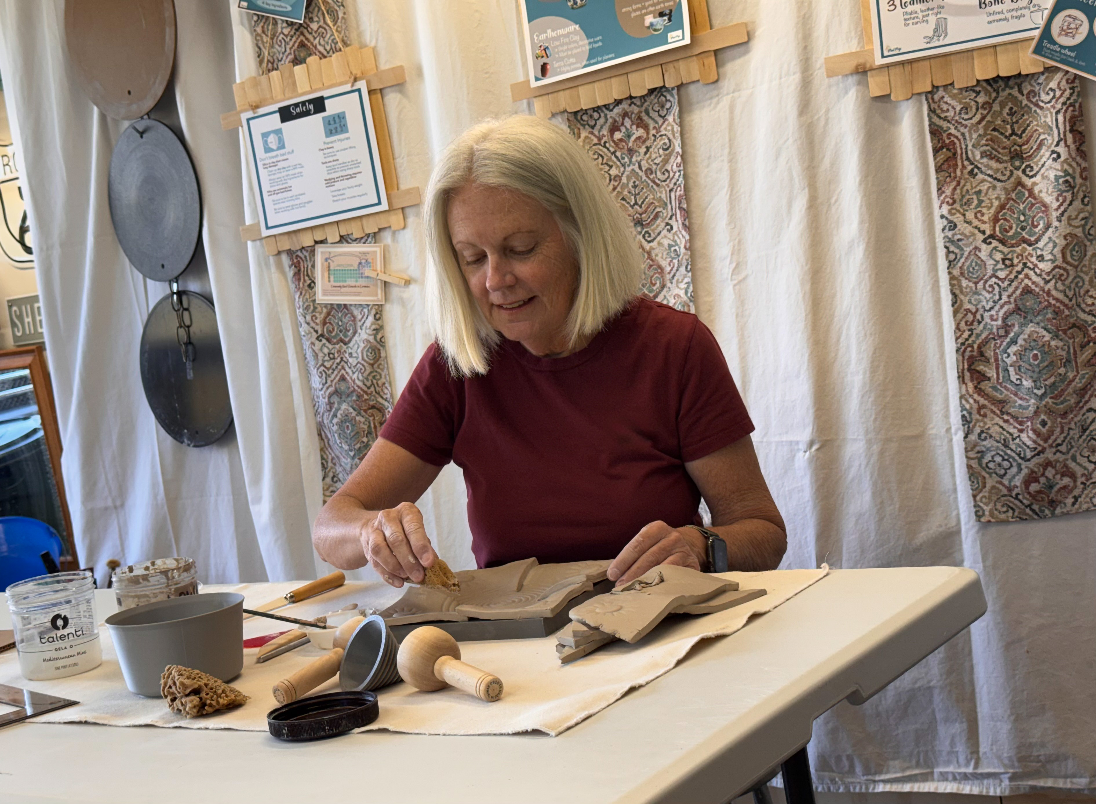 Johanna working at her pottery table