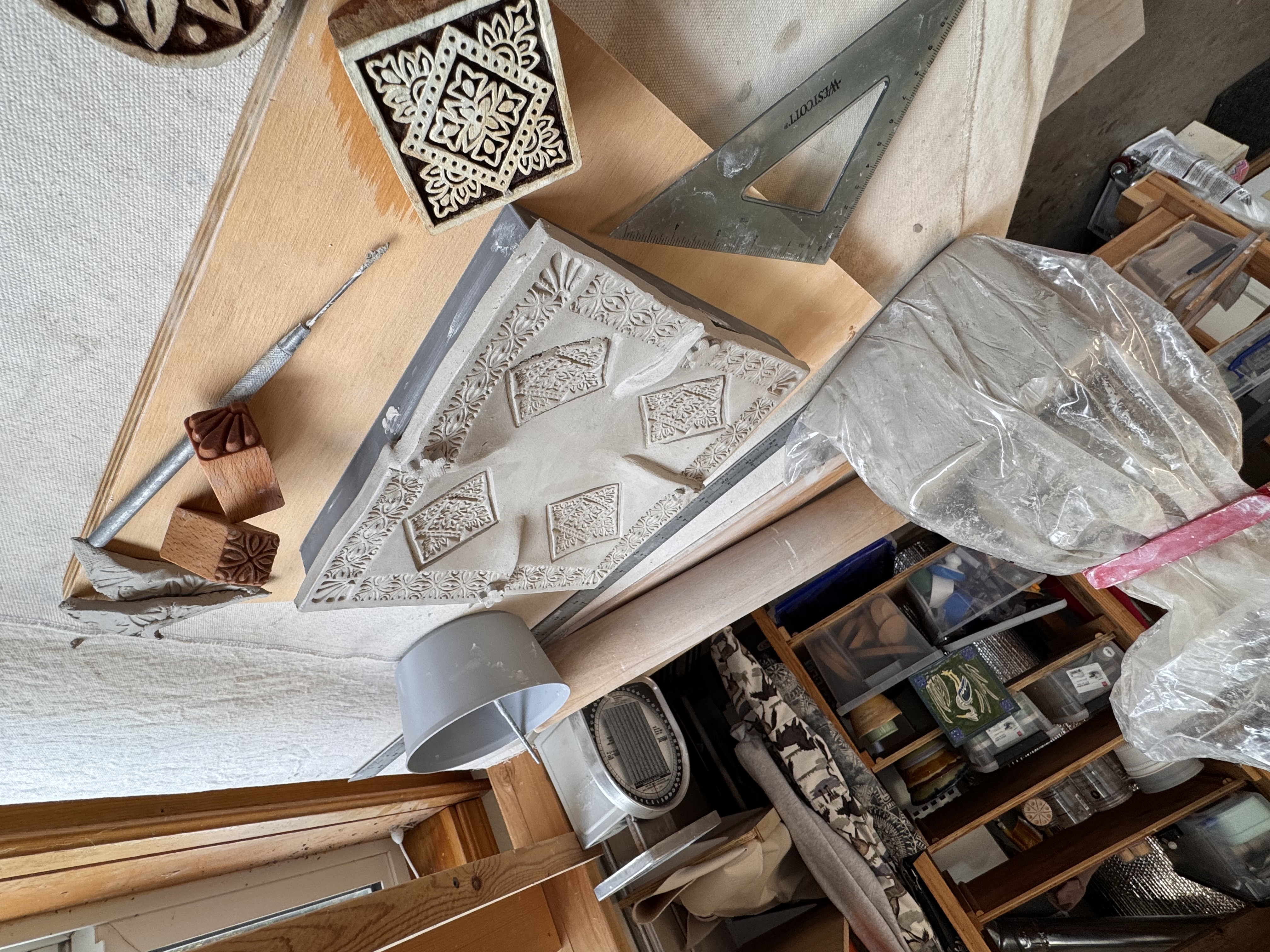 Greenware ceramic pieces drying in the studio