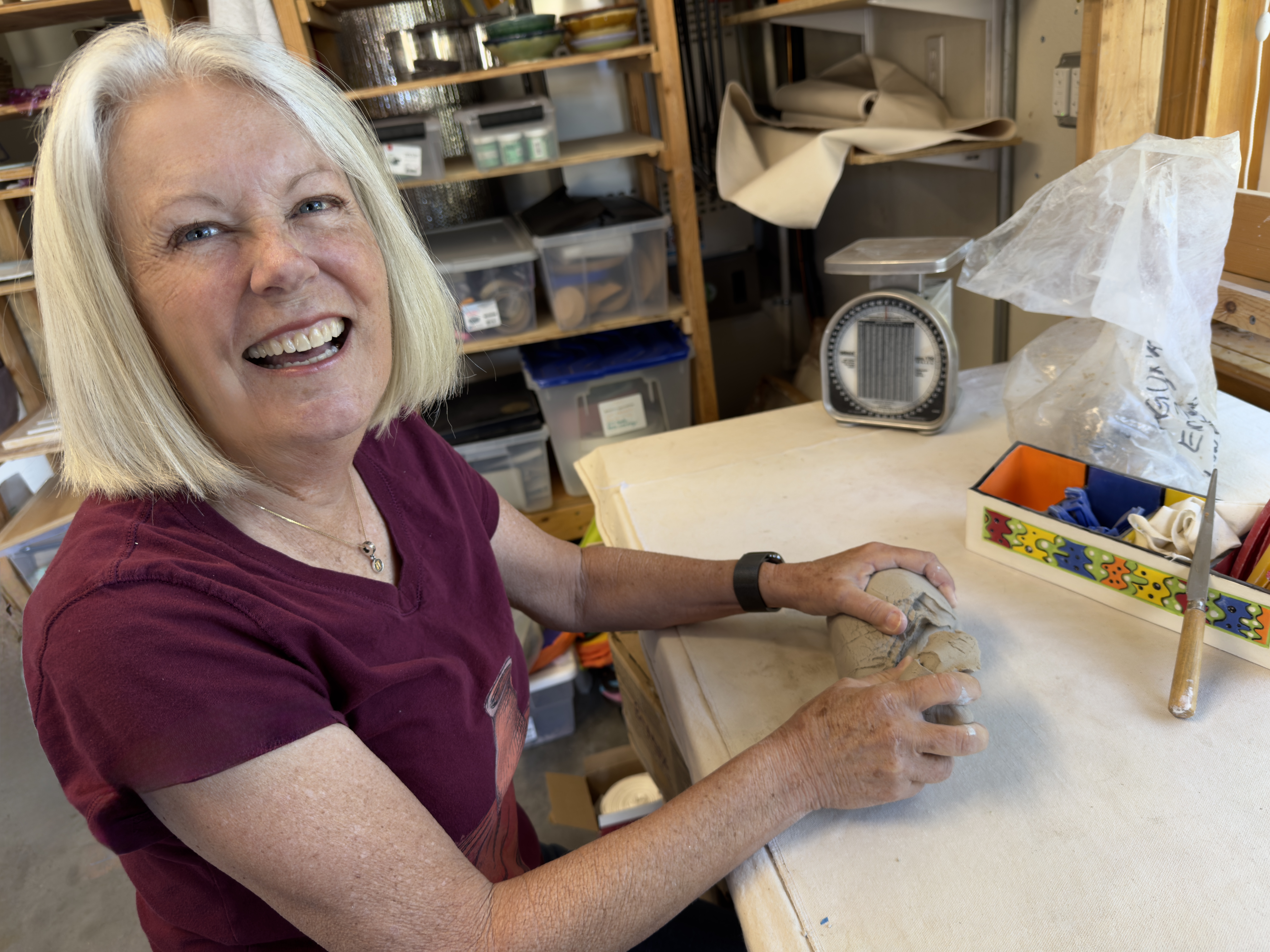 Johanna working with clay at her pottery bench